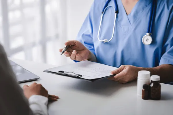 doctor-talking-patient-filling-history-600nw-2311370465
